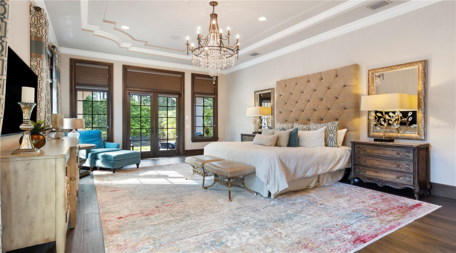 Expansive primary with porch overlooking pool and conservation