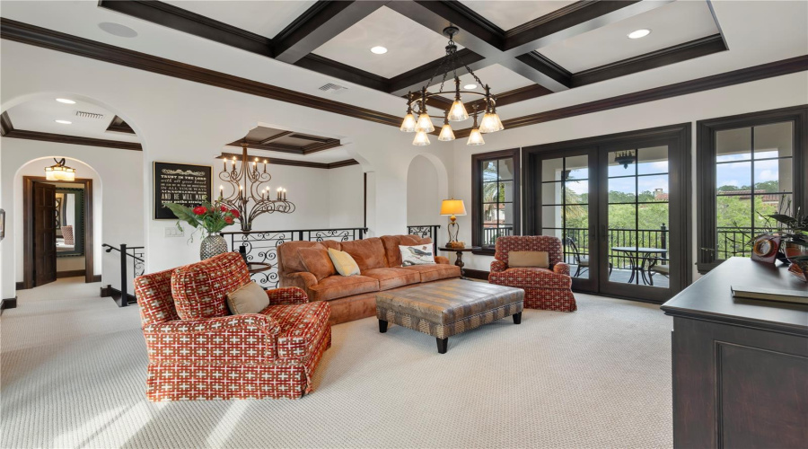 Second floor multipurpose room, separating guest suites, with balcony access on the front and back of home