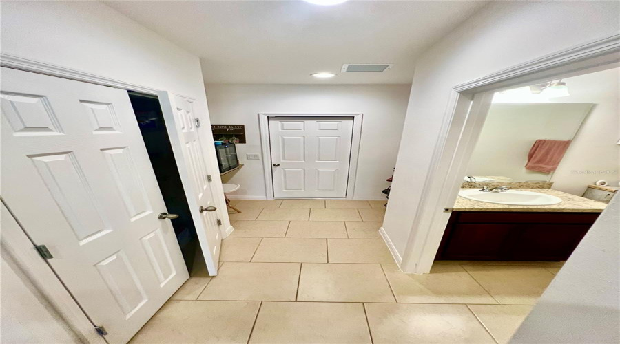 Pantry, half bathroom, coffee or wine area, and garage door.