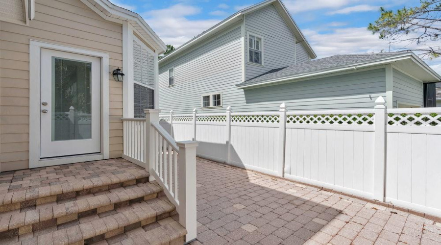 Paver Backyard With Vinyl Fence