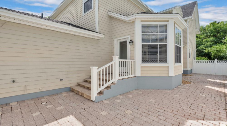 Paver Backyard With Vinyl Fence