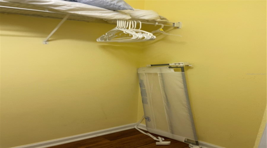 walk-in closet in buck room bed rail extra bedding