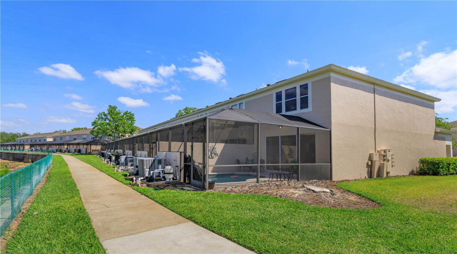 Green space behind unit with a walk way