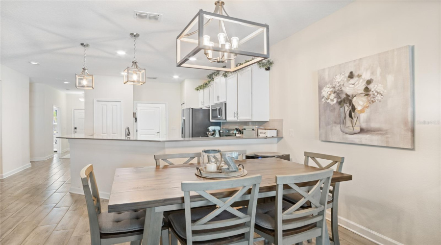 Looking From The Living Room To The Kitchen, Which Leads Either To The Laundry Room And Garage Or The Front Door, And Guest Bedroom And Guest Bathroom.