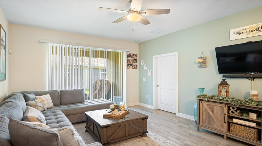A View Of The Living Room Looking Toward The Primary Bedroom And The Sliding Glass Door.