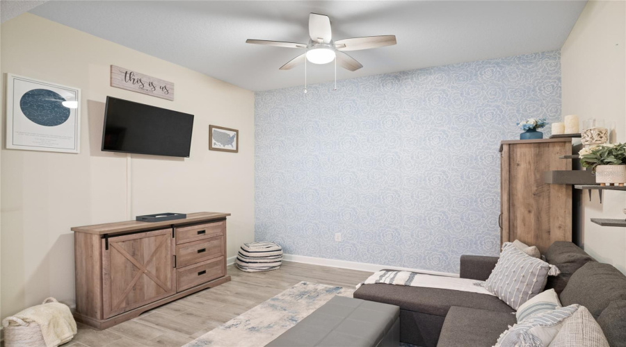 The Bonus Room/Den/Office/Play Room Has An Accent Wall With A Soothing Blue Color.