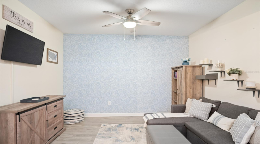 Another View Of The Bonus Room With The Wood Plank Flooring And A Ceiling Fan.