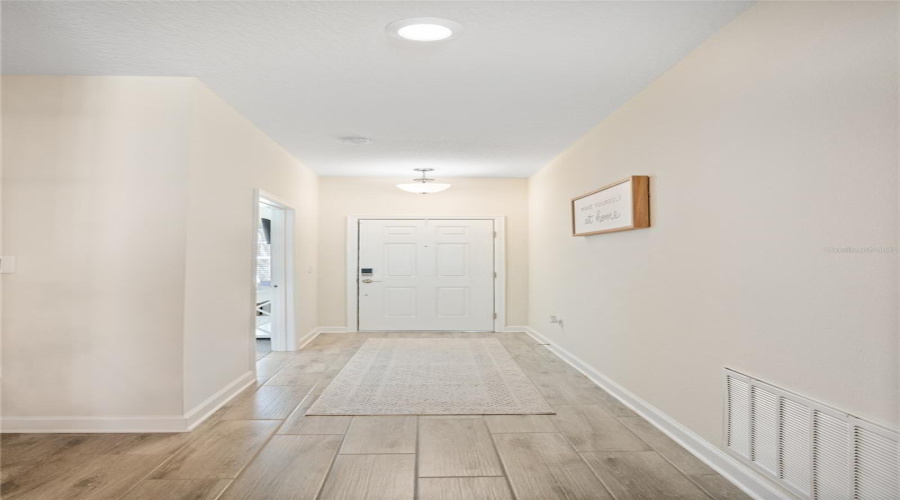 A Look Down The Entry Way To The Front Door With The Guest Quarters Off To The Left.