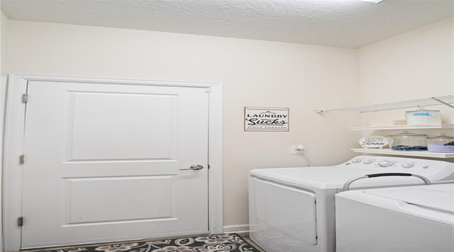 The Laundry Room Provides Shelves And A Storage Closet.  The Door Shown Takes You To The Garage.