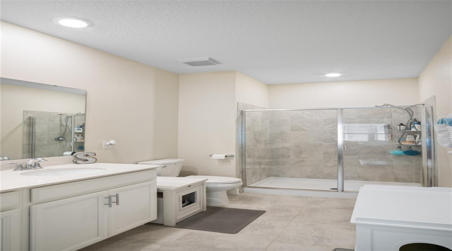 The Primary Bathroom Has Double Sinks And A Shower Stall.