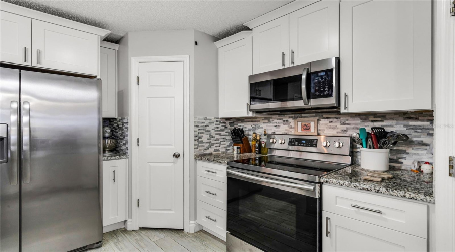 Granite - White Cabinets With Stainless Steel Appliances