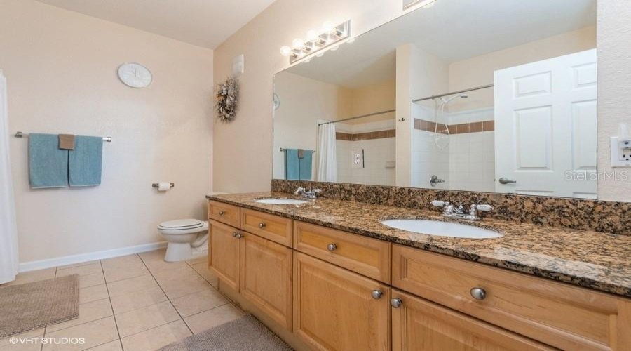 A Well-Appointed Primary En Suite Bathroom Showcases Dual Sinks And A Separate Walk-In Shower, Perfect For A Streamlined Morning Routine.