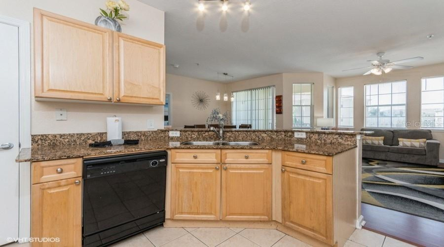Granite Countertops In The Kitchen Along With Sleek Black Appliances, Provide Both Style And Function.