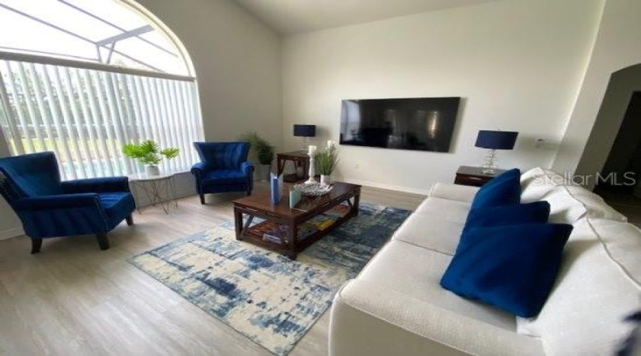 Spacious Living Area With Pool Side Views And Sliding Door Access.
