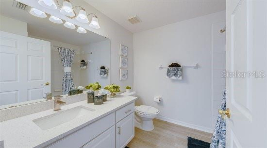 Guest Bathroom With Quartz Counter And Updated Vanity Lighting