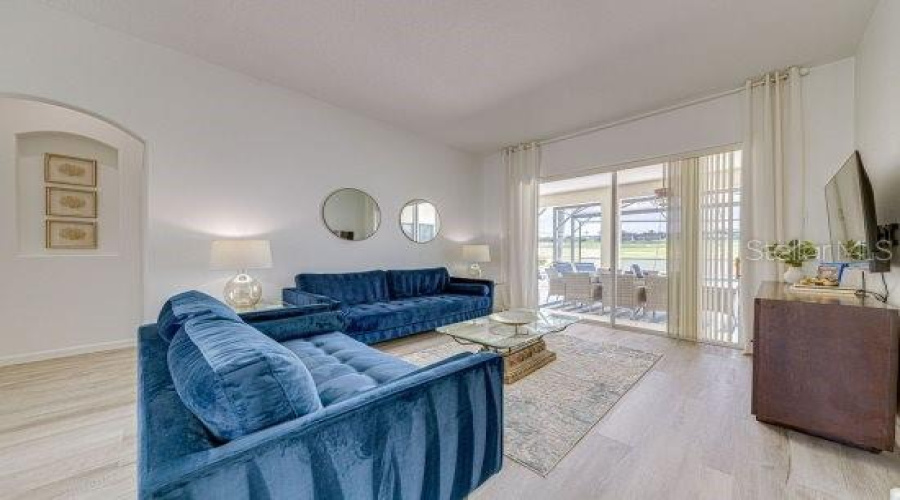 Formal Living Space Featuring Sliding Patio Doors On To The Pool Deck