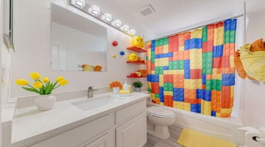Shared Guest Bathroom With Sparkle Quartz Countertop, New Plumbing And Faucet With Updated Vanity Lighting.