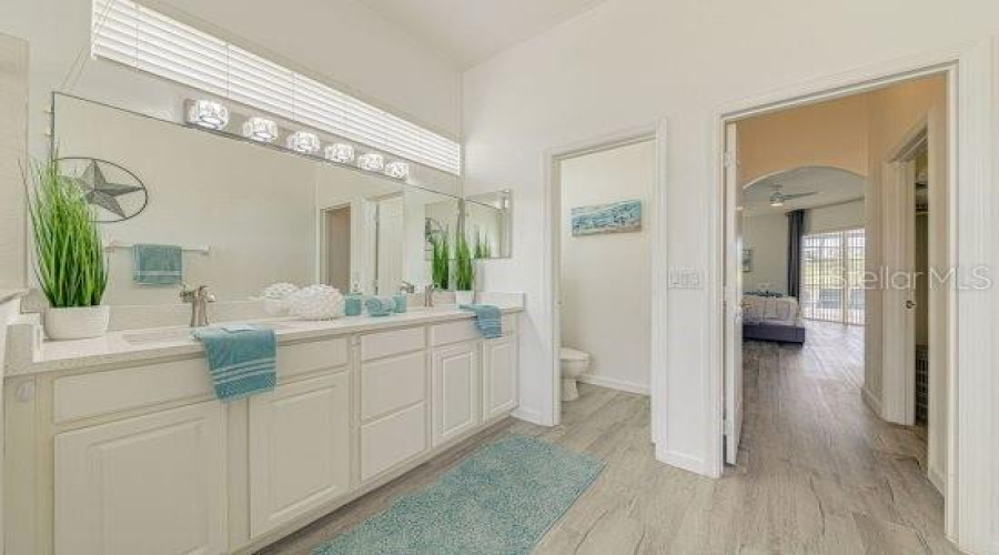 Primary Ensuite Bathroom With Dual Vanity, Quartz Countertop, Updated Vanity Lighting, Separate Wc, Garden Tub And Separate Shower Stall.