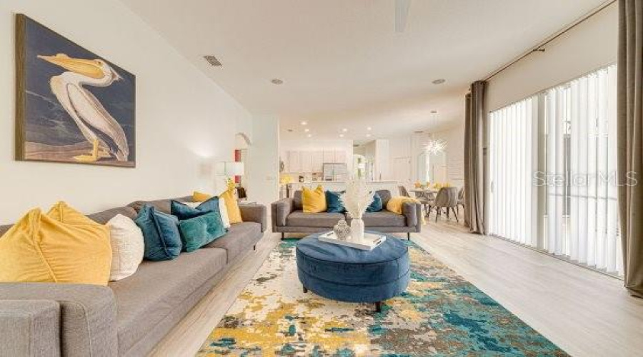 Main Living Room Has Sliding Door Access On To Private Pool Deck, With Lvp Throughout And Tastefully Decorated