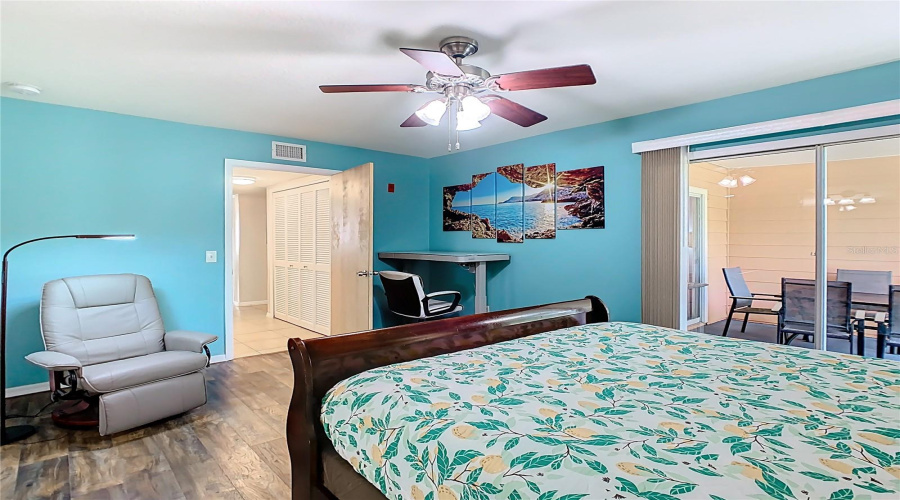 1 of 2 bedrooms with ensuite bath and sliding door access to covered lanai.