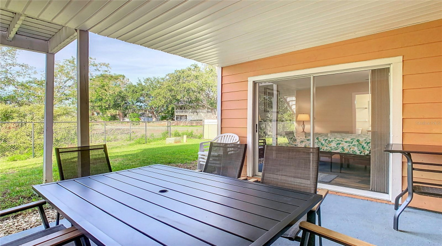 Private outdoor space. Covered lanai. Solid ceiling to prevent dirt and debris from falling through, added by seller. Property backs to wooded area - no rear neighbors.