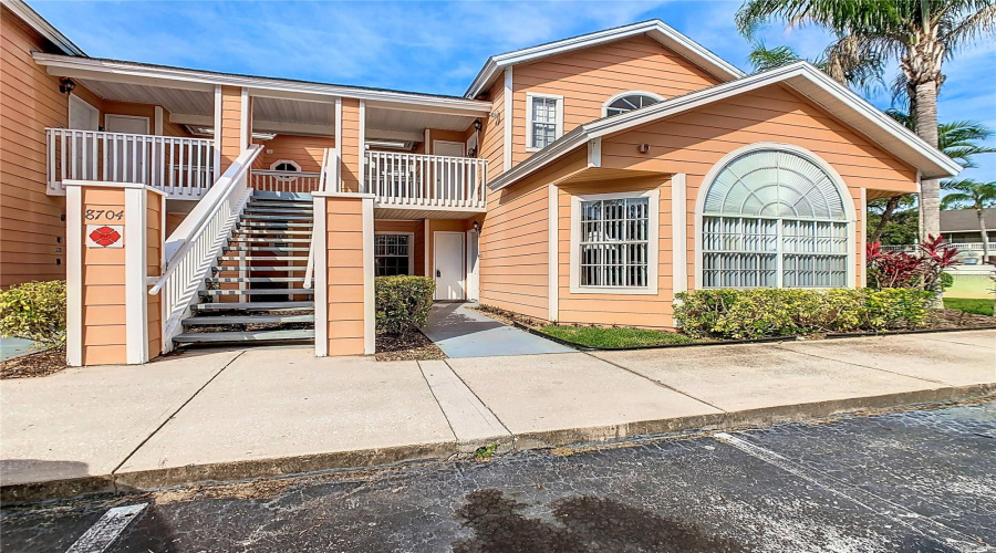 Exterior front of 1st floor, corner unit. 4 bed/3 bath, 1616 sq ft heated plus outdoor covered patio/lanai. Prime location - Short and Long-term rental possibilities.