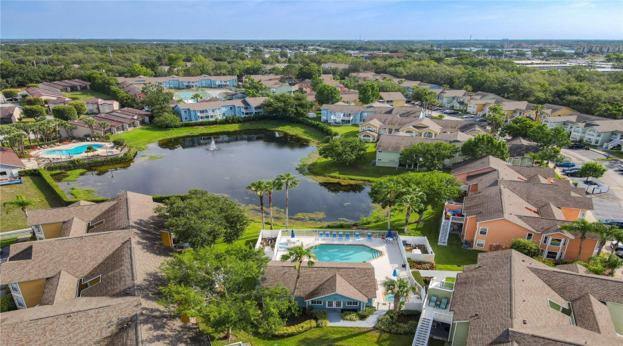 Clubhouse #2 across pond behind blue building with additional amenities.