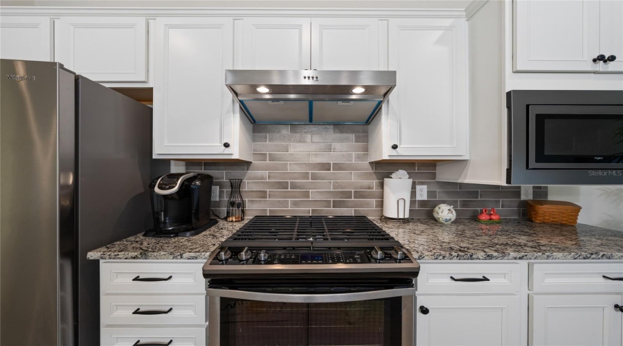 Beautiful Backsplash, Granite Counters, Stainless Steel Whirlpool Appliances