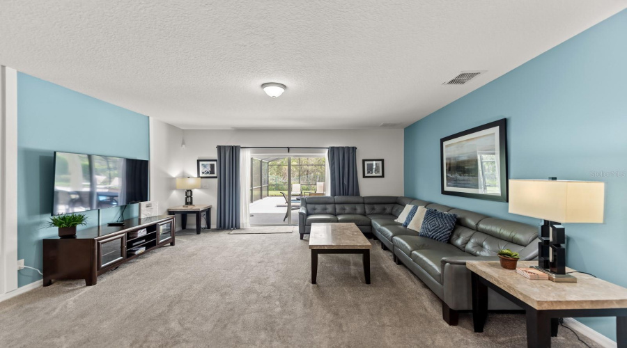 Homey Family Room Sits Alongside The Kitchen And Provides Access To The Covered Lanai And Your Personal Pool