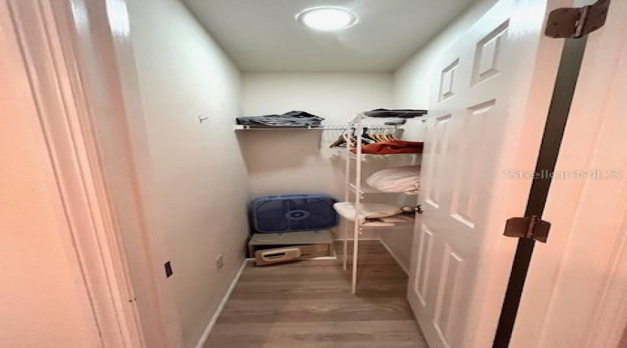 Walk-In Closet With Shelving And Safe