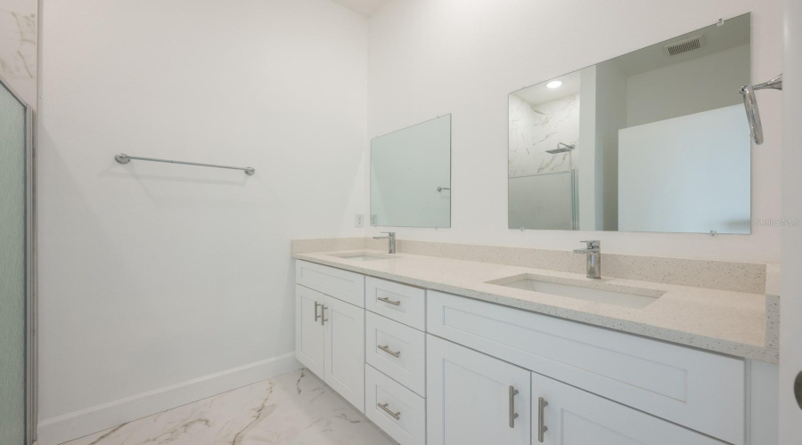 Designed for comfort, the en suite bath in the 2nd-floor Master offers dual sinks and a walk-in shower.