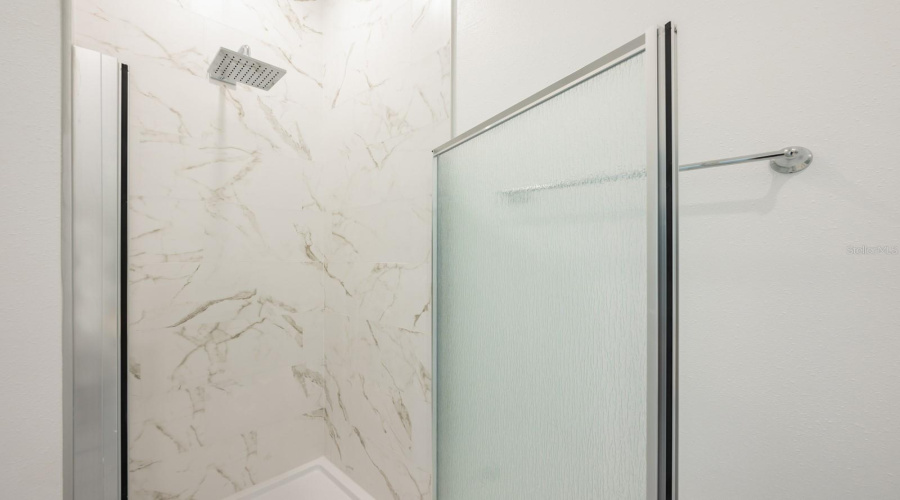 Rain shower heads in all four bathrooms elevate the everyday routine with a luxurious, spa-like feel.