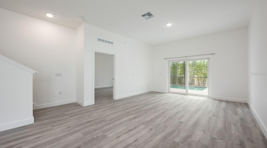 Bright and welcoming, the Living Room offers abundant natural light and beautiful luxury plank flooring.