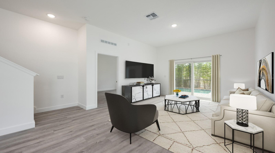 Bright and welcoming, the Living Room offers abundant natural light and beautiful luxury plank flooring. Virtually staged.