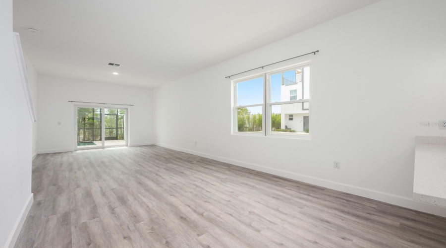 The open floor plan allows for effortless movement from the Living Room to the connected Dining space, ideal for relaxed living and gatherings.