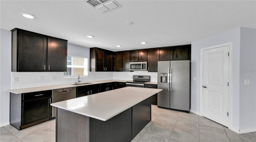 Kitchen with quartz countertops.