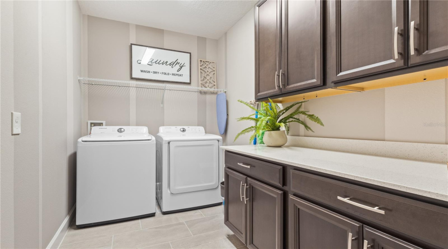 Oversized Laundry with Cabinets and Countertops