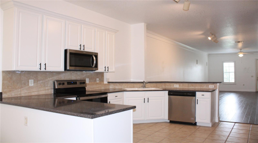 Extra Large Kitchen with White Resurfaced Cabinets with Crown Molding