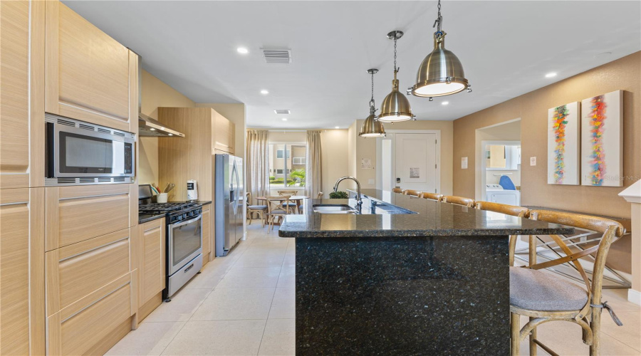 Kitchen showing laundry at the top right of the picture and breakfast area at the top left of the picture.