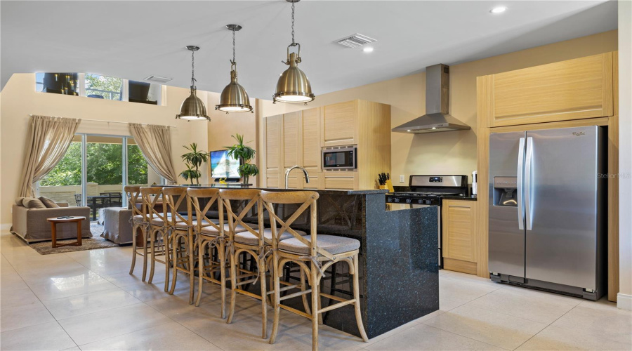 Another view of kitchen showing living area connected.