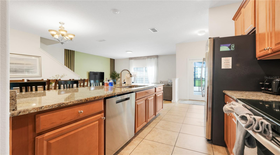 fully stocked open concept kitchen with granite countertops