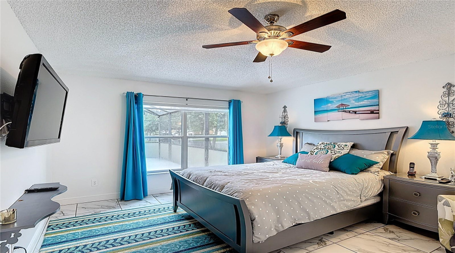 Primary bedroom overlooking patio pool area