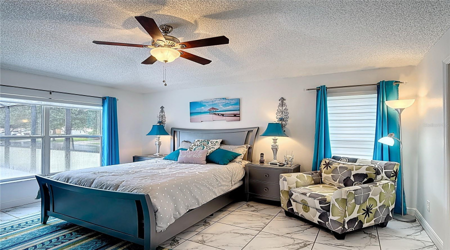 Primary bedroom overlooking patio pool area