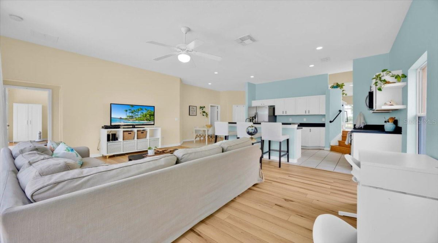 Part of this spacious family room is thoughtfully used as a study area for at-home learning, showcasing the home’s flexibility and smart layout. The practical waterproof flooring throughout offers durability and peace of mind for everyday living.