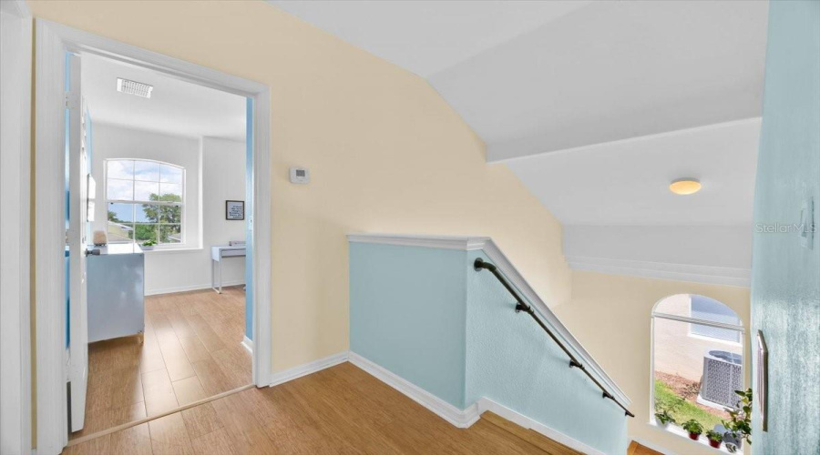 At the top of the stairs, the first bedroom greets you with an abundance of natural light. Currently used as a home office and creative content space, this room is perfect for remote work, studying, or pursuing your passions—just like it's done here!Al subir las escaleras, el primer dormitorio te recibe con una gran entrada de luz natural. Actualmente se utiliza como oficina en casa y espacio creativo para contenido digital, ideal para trabajar desde casa, estudiar o dar vida a tus pasiones—¡tal como se hace aquí!