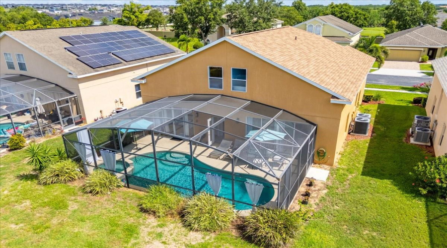 Bird's-eye view of paradise!Newer roof, a sparkling pool with spa, and a beautifully landscaped yard—your private oasis awaits.Español:¡Vista aérea del paraíso!Techo reciente, piscina brillante con spa y un jardín bellamente diseñado—tu oasis privado te espera.