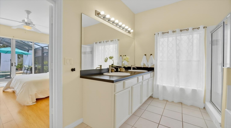 Guest/In-Law Suite Bathroom:Stylish and serene, this private en-suite bathroom stands out with a refreshed double vanity in a classic antique white finish, paired with sleek black countertops and modern brushed nickel hardware. Thoughtful upgrades like a contemporary faucet and towel holder elevate the space, giving it a clean, updated look. Connected directly to the guest or in-law suite, this bathroom offers comfort, functionality, and a touch of elegance.ESPAÑOL:Baño de la Suite de Invitados o Suegros:Con un estilo elegante y sereno, este baño privado tipo en-suite se destaca por su tocador renovado en un clásico tono blanco antiguo, con encimeras negras y herrajes modernos en níquel cepillado. Mejoras discretas como un grifo contemporáneo y un nuevo toallero realzan el espacio, dándole un aire limpio y actualizado. Con acceso directo desde la habitación de invitados o suegros, este baño ofrece comodidad, funcionalidad y un toque de elegancia.