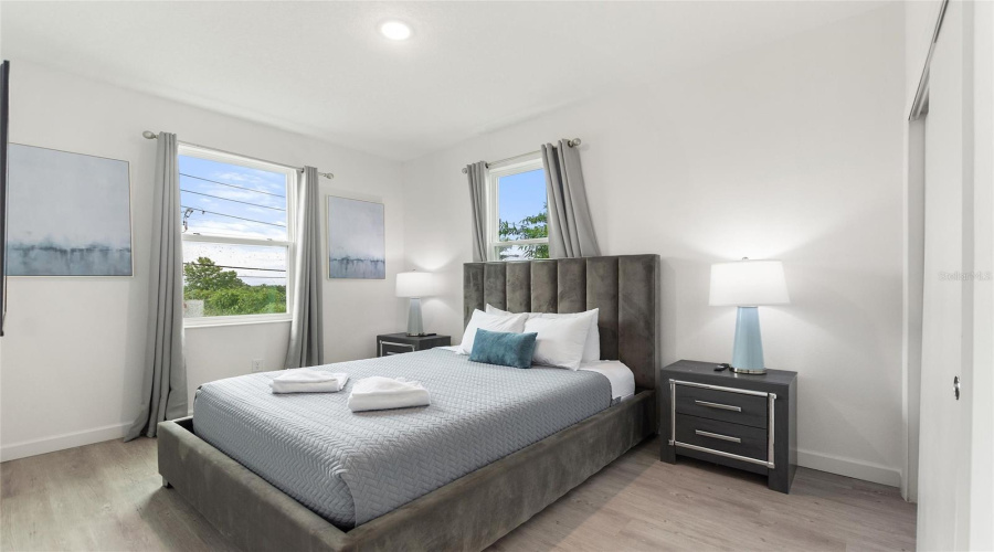 Bedroom 2 with Queen sized bed and flat screen TV.
