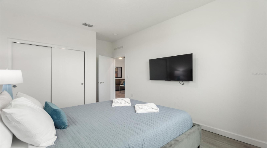 Bedroom 2 with Queen sized bed and flat screen TV.