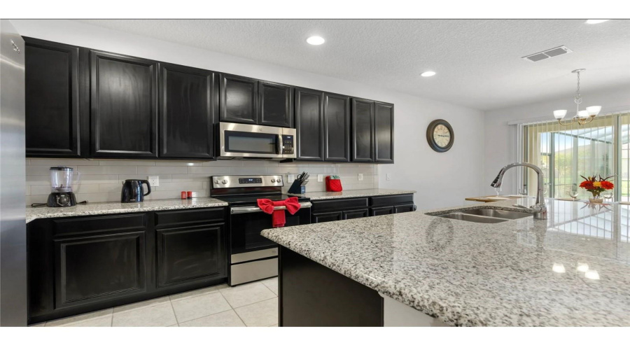 Stone Countertops throughout the open plan kitchen complimented by dark wooden cabinets